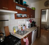 Na predaj - zrekonštruovaný 2-izbový byt Snina - Kuchyňa v 2-izbovom byte s tmavým nábytkom a kuchynskými spotrebičmi.