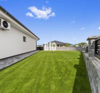 Moderný 4i dom v RED OAK, Lužianky | Kompletné zariadenie! - Záhrada rodinného domu v Nitre s trávnikom a kamennou dlažbou pri stene.