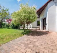 REZERVOVANÉ_RD v Nitre, Veľké Janíkovce – 994 m2 pozemok - Rodinný dom v Nitre s terasou, záhradou a stromami na trávnatej ploche.