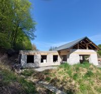 NA PREDAJ rozostavaný 5-izbový rodinný dom   - Stavba rodinného domu vo Zvolene, obklopená lesom a prírodou, pod modrou oblohou.