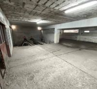 Garáž na ul. Chlumeckého, Ružinov - Betónový interiér v garáži so schodiskom a osvetlením.