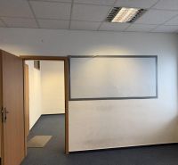 Kancelárske, obchodné a skladové priestory od 14m2 do 500m2 v areáli. - Kancelária s kobercom, oknom a otvorenými dverami vo Skladoch a halách.