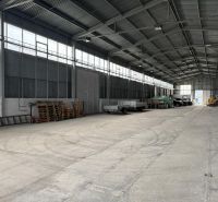 Sklad. priestory 200m2 - 1000m2, spevnené plochy do 6000m2 v areáli. - Interiér skladov a hál s betónovou podlahou a zaparkovanými vozidlami a prívesmi.