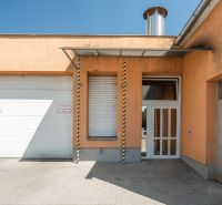 I PREDAJ – FUNGUJÚCA PEKÁREŇ A POTRAVINY V TRNAVE - Výrobné priestory na Koniarekovej ulici v Trnave s oranžovou fasádou a vrátami.