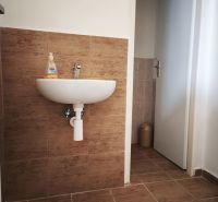 Prenájom obchodno-administratívneho priestoru , Šaľa  centrum - Umývadlo s dekorom dlaždíc v obchodných priestoroch s podlahou s dreveným dekorom.