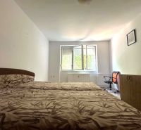 ☎️ 0918197701 Na prenájom  zariadený 1 izbový byt  na sídlisku západ n - Spálňa v 1-izbovom byte s otvoreným oknom, kreslom a skrinkou.
