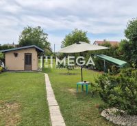 PREDAJ RODINNÉHO DOMU v obci LACKOVCE (HE) - Záhrada rodinného domu v Lackovciach s trávnikom, posedením a drobnou stavbou.