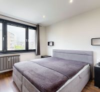 BENADOVA - 4-IZBOVÝ BYT PO KOMPLETNEJ REKONŠTRUKCII, 79 m², LOGGIA  - Spálňa v 4-izbovom byte s veľkým oknom a podlahou s dreveným dekorom.
