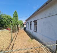 RD Otrokovce 1071m pozemok - Rodinný dom v Dolných Otrokovciach s oplotením a príjazdovou cestou na dvore.