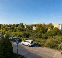 Slnečný 2-izb. byt, terasa a balkón, Stupava, V. Šikulu - Exteriér na ulici Vincenta Šikulu v Stupave, s pohľadom na parkovisko a zeleň, 2-izbový byt.