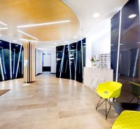 Kancelárie od 25,7 m² s parkovaním, recepcia 24/7 – Košická ul., Nivy - Recepcia kancelárií s podlahou s dreveným dekorom a zeleňou na stene.