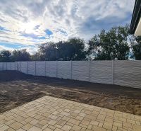 / Novostavba, moderný bungalov, dokončený na kľúč  - Pavlač rodinného domu v Senci pri plote, čiastočne zatienená slnkom.