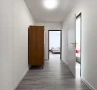 NA PRENÁJOM! Slnečný a zariadený 3i byt 68 m2, ul. Švermova, Trenčín - Chodba s podlahou s dreveným dekorom v 3-izbovom byte, tmavá skriňa, dvere do izieb.