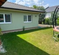 Novostavba 5 izbového rodinného domu v Jarku - Záhrada rodinného domu v Jarku so zeleným trávnikom a trampolínou.
