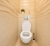 Na prenájom zariadený 4-izbový byt s balkónom I Ružinov |  - Toaleta v 4-izbovom byte s béžovým obkladom a minimalistickým dekorom.