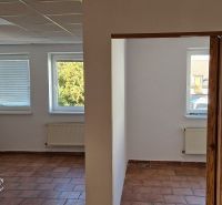 NA PREDAJ – polyfunkčný objekt v úplnom centre mesta Senec - obchodný  - Obchodné priestory s oknami, dlažbou a bielymi stenami, dva vykurovacie radiátory.