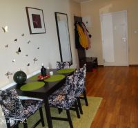 REZERVOVANÉ - 2 izbový veľký celoročne obývateľný apartmán s terasou,  - Jedáleň v 2-izbovom byte s podlahou s dreveným dekorom a dekoráciami na stene.