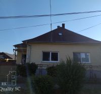 HAMULIAKOVO – NA PREDAJ – starší 5 izbový rodinný dom po čiastočnej re - Rodinný dom v Hamuliakove s hnedou strechou a predzáhradkou s kríkmi.