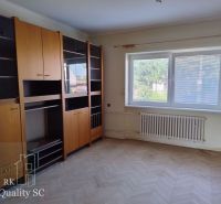 HAMULIAKOVO – NA PREDAJ – starší 5 izbový rodinný dom po čiastočnej re - Obývacia izba s nábytkom, podlaha s dreveným dekorom, veľké okno.