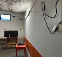 PREDAJ - Garáž na s pozemkom na Pionierskej ulici  - Garáže s osvetlením na Pionierskej ulici v Bratislave - Nové Mesto, s oknom a stolíkom.