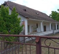 Vidiecky domček na predaj. - Rodinný dom v Ňárade s bielou fasádou a šikmou strechou s dreveným plotom.
