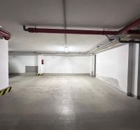Na prenájom menšia  kancelária v centre mesta DS - 12,94 m2 - Podzemné parkovisko s betónovým povrchom a červenými potrubiami v kancelárskych priestoroch Dunajskej Stredy.