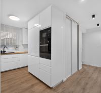 4i RD s pozemkom 170 m2  | ul. Vážska | Trenčín - Kuchyňa s bielymi skrinkami, vstavanými spotrebičmi a podlahou s dreveným dekorom v rodinnom dome.