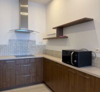 3 Izbový byt na Námestí Slobody v stave FIVE STAR na prenájom - Kuchyňa v 3-izbovom byte s dreveným dekorom a zabudovanými spotrebičmi.
