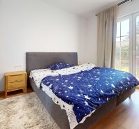 PRENÁJOM 2 izbový, zariadený byt v Danube residencia - REZERVOVANÉ - Spálňa v 2-izbovom byte s dvojlôžkom, nočnými stolíkmi a podlahou s dreveným dekorom.