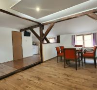 Na predaj zabehnutý Apartmánový dom v Podhájskej s parkovaním - Jedáleň s drevenými trámami a podlahou s dreveným dekorom v Rekreačnom apartmáne.