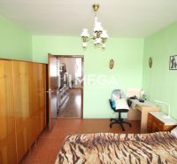 DOHODA NA CENE NA PREDAJ 4-IZBOVÝ BYT 88 m² S LOGGIOU HUMENNÉ - Izba so zelenými stenami, drevenou skriňou a pracovným stolom v 4-izbovom byte.