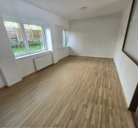 PRENÁJOM Bánovce nad Bebravou/2 IZBOVÝ BYT/CENTRUM-STRED/70m2 - Izba s veľkými oknami a podlahou s dreveným dekorom v 2-izbovom byte.