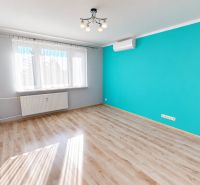 PREDANÉ !!! (74 m²) SVETLÝ 3i BYT S LOGGIOU - Pokoj v 3-izbovom byte s modrou stenou a podlahou s dreveným dekorom.
