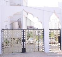 2-IZBOVÝ CONDO APARTMÁN PRI PLÁŽI, MBWENI, ZANZIBAR - Vstupná brána pri 2-izbovom byte na ulici Mbweni v Zanzibare s dekoratívnymi kovovými prvkami.