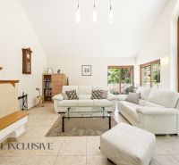 SÚKROMNÉ SÍDLO NA KONCI KÚPEĽNÉHO PARKU | 4 454 m² | TRENČ. TEPLICE - Obývačka v rodinnom dome s bielymi sedačkami a veľkými oknami.