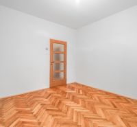  3-izbbyt s veľkou loggiou vo vyhľadávanej lokalite Bratisl - Prázdna miestnosť s drevenou podlahou a dverami v 3-izbovom byte.