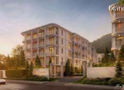 Výstavba bytov v Phuket, elegantná budova obklopená zeleňou za súmraku.