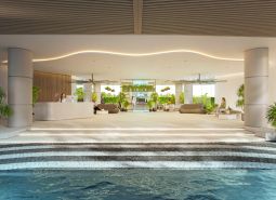 Interiér bytovej výstavby s recepciou a relaxačnou zónou, zdobené zeleňou a sedením.