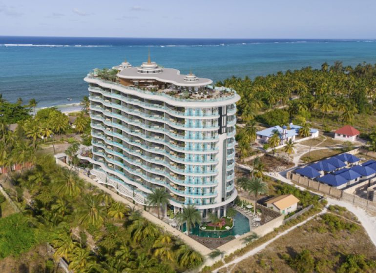 Predaj 2-izbového bytu, Paje Zanzibar - Apartmánový komplex pri pláži v Paje s výhľadom na oceán a palmovými stromami.