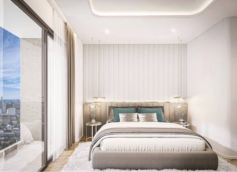 1 IZBOVÝ APARTMÁN (1 SPÁLŇA + 1 OBÝV. IZBA) SEASPIRE JOMTIEN PATTAYA - Spálňa v 2-izbovom byte s výhľadom na panorámu mesta Pattaya.