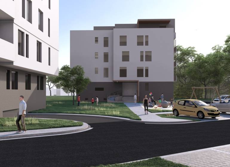 NOVOSTAVBA -2 izbový byt s komorou, na predaj  Galanta - Budova v Galante, okolie s ľuďmi, autami a ihriskom, ponuka 2-izbového bytu.