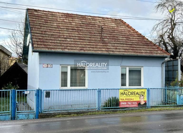 Predaj, rodinný dom Prievidza - EXKLUZÍVNE HALO REALITY - Jednopodlažný rodinný dom v Prievidzi, modré fasády, šikmá strecha, kovový plot.
