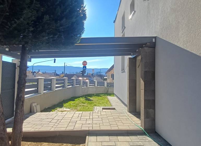 PREDAJ/ Kompletne zrekonštruovaný rodinný dom v Rožňave - Dvor rodinného domu na Košickej ulici v Rožňave s dreveným plotom a stromom.