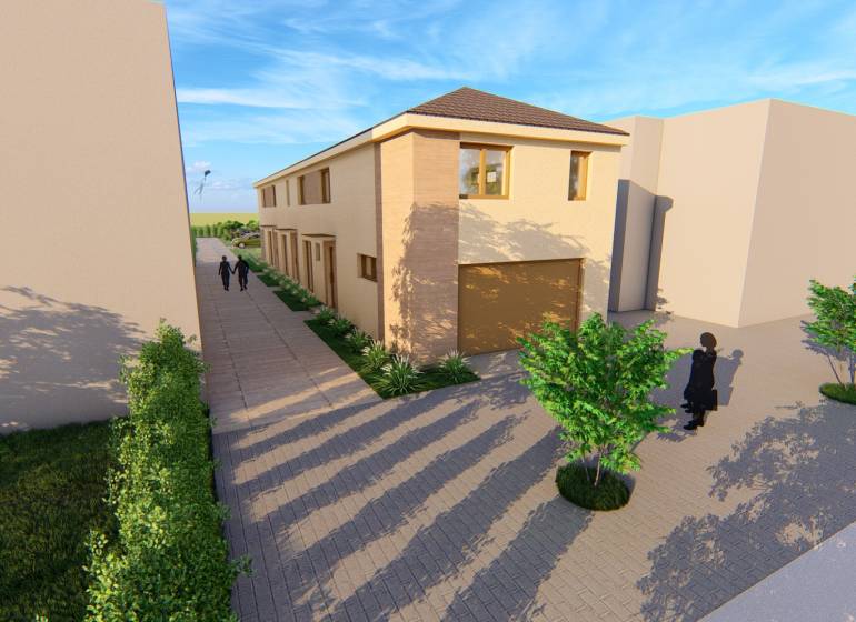 PREDPREDAJ – 2-izbový tehlový mezonet s pozemkom | Topoľčianky - Dvojposchodová budova s cestou na Litoměřickej ulici v Topoľčiankach, s okolitými stromami.