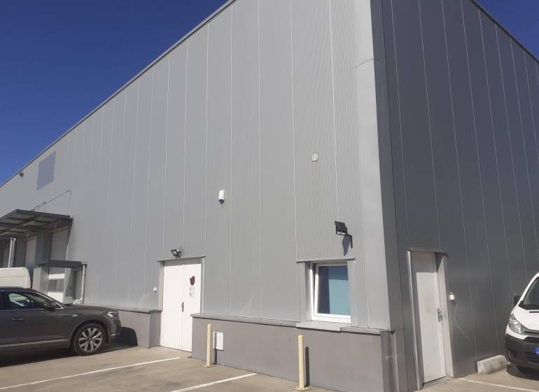 Prenájom skladu 670 m2 neďaleko letiska, IKEA - Sklady a haly na Technickej ulici v Bratislave-Ružinove, s parkovanými autami pred vstupom.