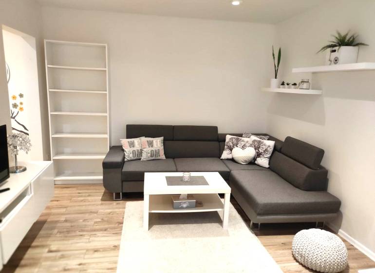 2-izbový byt, 49 m2, Cabanova ul., Bratislava - Dúbravka - Obývačka s rohovou sedačkou v 2-izbovom byte na ulici Cabanova. Štýlové doplnky.