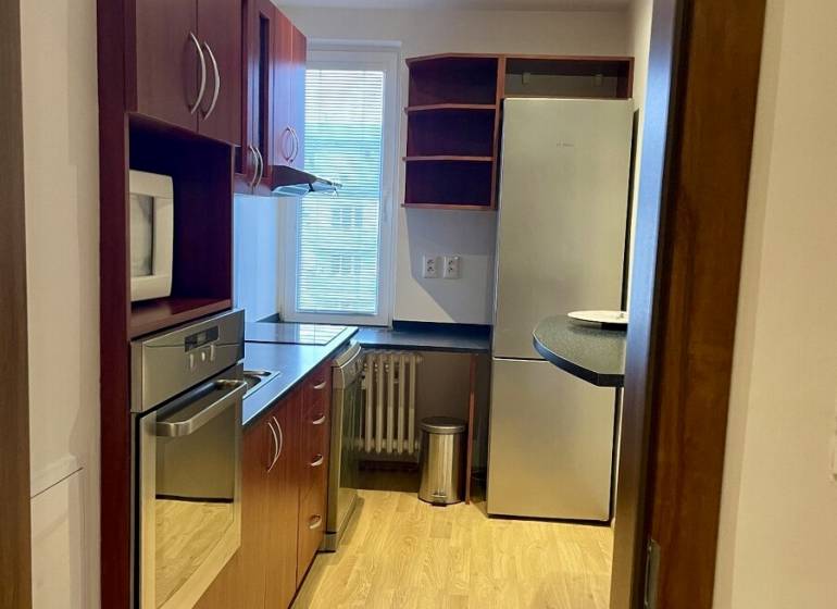 Prenájom 2-izb kompletne zariadený PET FRIENDLY byt BA II - Kuchyňa v 2-izbovom byte s dreveným dekorom podlahy a vstavanými spotrebičmi.