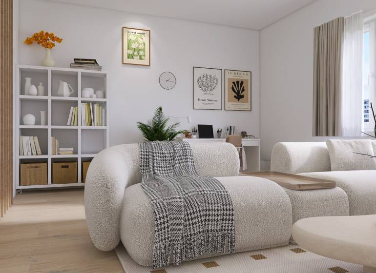 PREDANÉ - 4 izbový byt s loggiou v Petržalke - Svetlá obývačka v 3-izbovom byte s pohodlným nábytkom a poličkami plnými kníh.