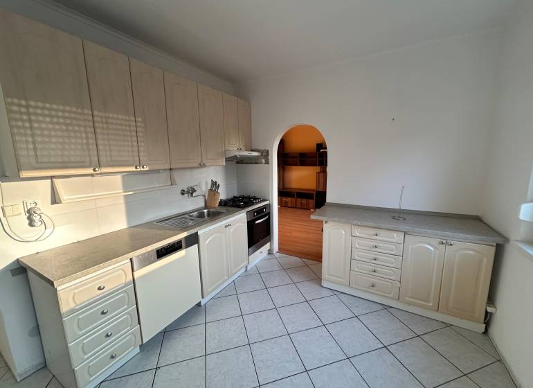 Predaj 3 izb. bytu s balkónom v NZ - Kuchyňa v 3-izbovom byte s bielymi skrinkami a kachličkovou podlahou.