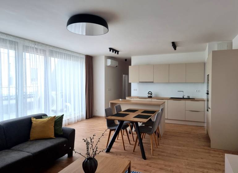 PRENÁJOM - 3 izbový byt Nitra – Piesková ulica, RIVIERA NITRA - Obývacia a kuchynská časť v 3-izbovom byte s podlahou s dreveným dekorom.